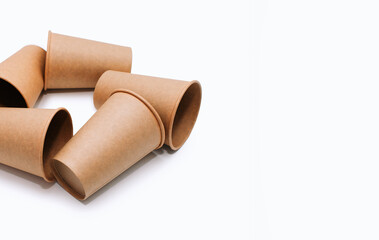 Disposable coffee cup on a white background with free space for text. Cardboard empty cups that can be recycled. Disposable paper cups. Concept without waste, without plastic