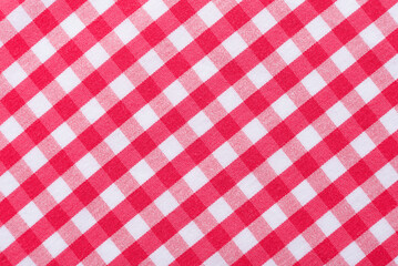The texture of linen fabric in a large cage of red  and white. Scottish tailoring material. Checkered fabric