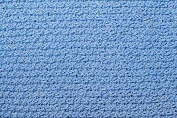Sweater or scarf fabric texture large knitting. Knitted jersey background with a relief pattern. Braids in knitting . Wool hand- machine, handmade, blue.