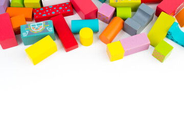 Top view of colorful wooden bricks on the table. Early learning. Educational toys on a white background.