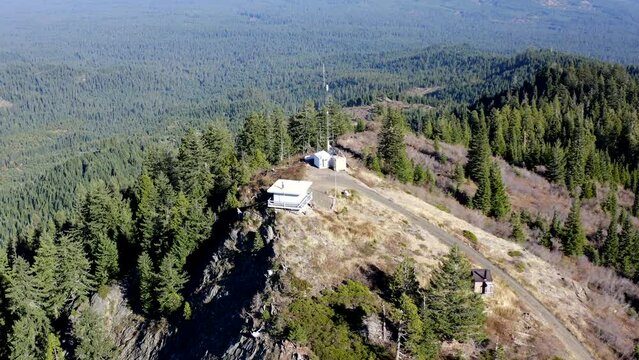 Fire lookout in the southern Oregon Cascades. The trees are green and the air is clear.