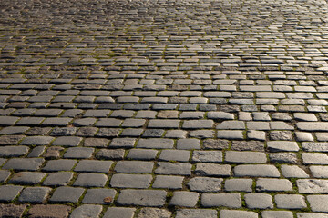 Square pavement paved with gray cobblestones rectangles texture