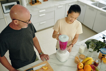 Mature couple making healthy breakfast together