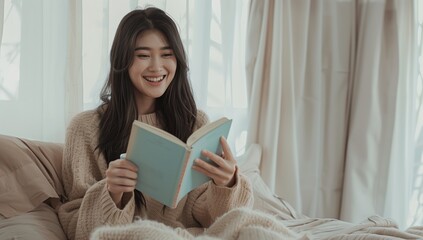 A beautiful woman is reading on the bed, smiling and holding an open book in her hand