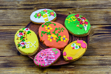 Easter cookies in plate on a wooden background