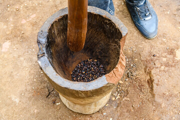 Grinding coffee in a mortar in Chagga tribe
