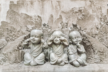 Three figurine children,, does not see, does not hear, does not speak.