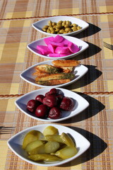 Table in a restaurant with a variety of
  snacks and food.