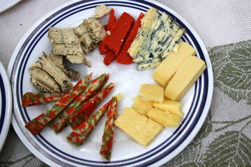 Table in a restaurant with a variety of
  snacks and food.