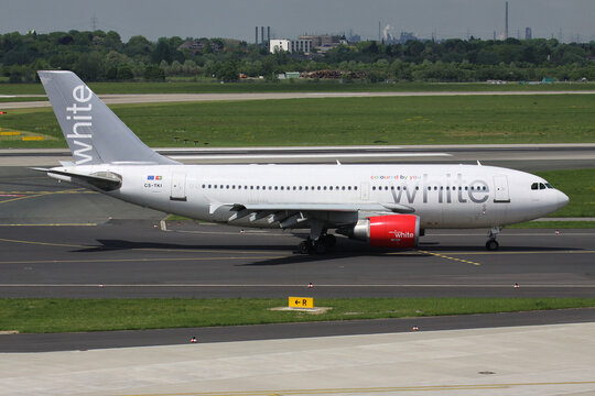Dusseldorf, Germany - May 13, 2012: Portuguese White Airways Airbus A310-300 with registration CS-TKI on taxiway at Dusseldorf Airport 