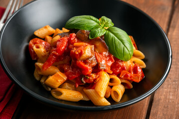 Piatto di pasta alla Norma, ricetta tipica della Cucina Siciliana, cibo italiano  - 786587112