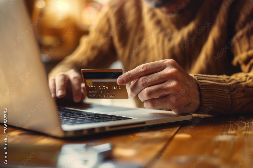 Poster a man holding a credit card while using a laptop. suitable for financial concepts
