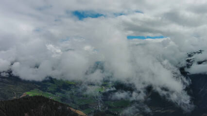 Aerial view of snowcapped mountains in clouds - 786588391