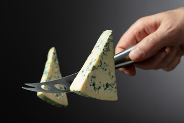 Cheese knife and piece of blue cheese.