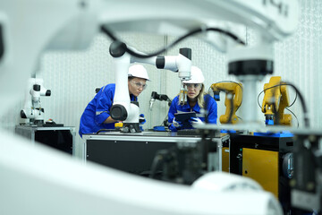 Engineer check and control welding robotics automatic arms machine in intelligent factory...