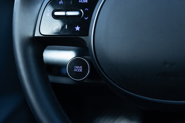 Drive mode button on luxury electric car dashboard. Relaxed and fuel efficient driving mode....