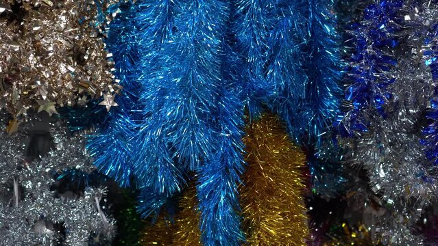 multicolored tinsel for decorating the house for the holidays hangs on a shop window, The concept of decorative decoration of the house for the holidays during the sale period