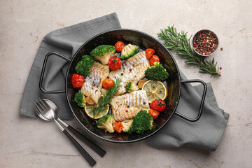 Tasty cod cooked with vegetables served on grey table, flat lay
