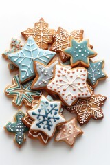 A pile of decorated cookies on a white surface, perfect for baking or holiday concept