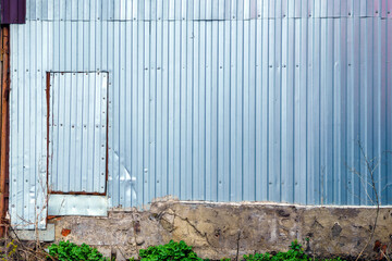 The door in the wall is made of gray tin