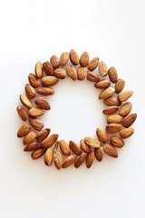 Obraz premium A circle of almonds on a white surface, suitable for food and nutrition concepts