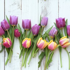 Colorful tulips arranged on a white table. Suitable for spring and floral concepts