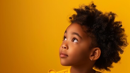 cute black girl of five on monochrome studio bright yellow background, lots of space for text,...