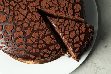 Delicious chocolate truffle cake on grey table, top view
