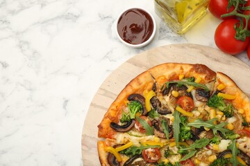Delicious vegetarian pizza served on white marble table, top view. Space for text