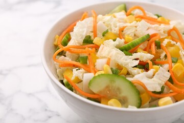 Tasty salad with Chinese cabbage, carrot, corn and cucumber in bowl on white marble table, closeup
