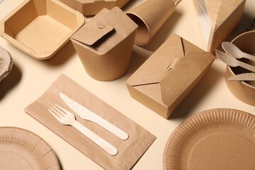 Eco friendly food packaging. Paper containers and tableware on beige background