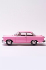 A pink toy car sitting on top of a white surface. Ideal for toy car enthusiasts or children's playroom decor