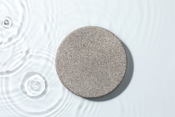 Presentation for product. Stone podium in water on white background, top view