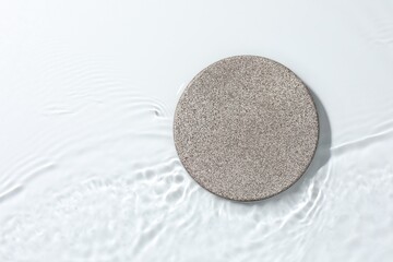 Presentation for product. Stone podium in water on white background, top view