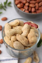 Fresh unpeeled peanuts on grey table, closeup