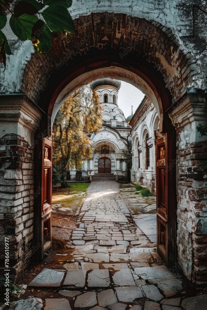 Poster An archway leading to a building with a clock tower. Suitable for architectural concepts