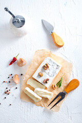 camambert cheese with nuts on white table
