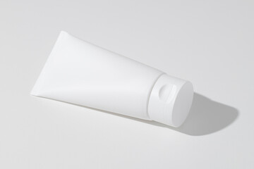 Empty white plastic tube for cosmetics. Mockup. Packaging for cream, gel, serum, advertising and product promotion