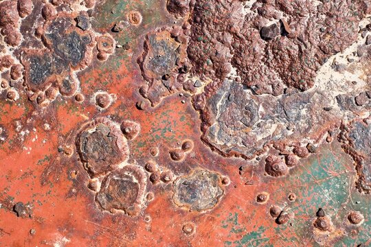 Rusty surface with many small holes - background old vintage rugged old