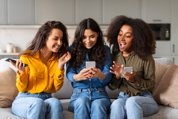 Group of friends looking at smartphone at home