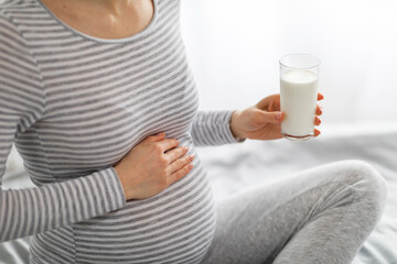 Pregnant woman holding a glass of milk