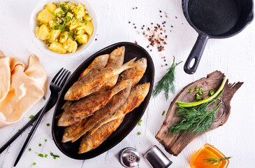 fried fish in pan on a table - 786622749