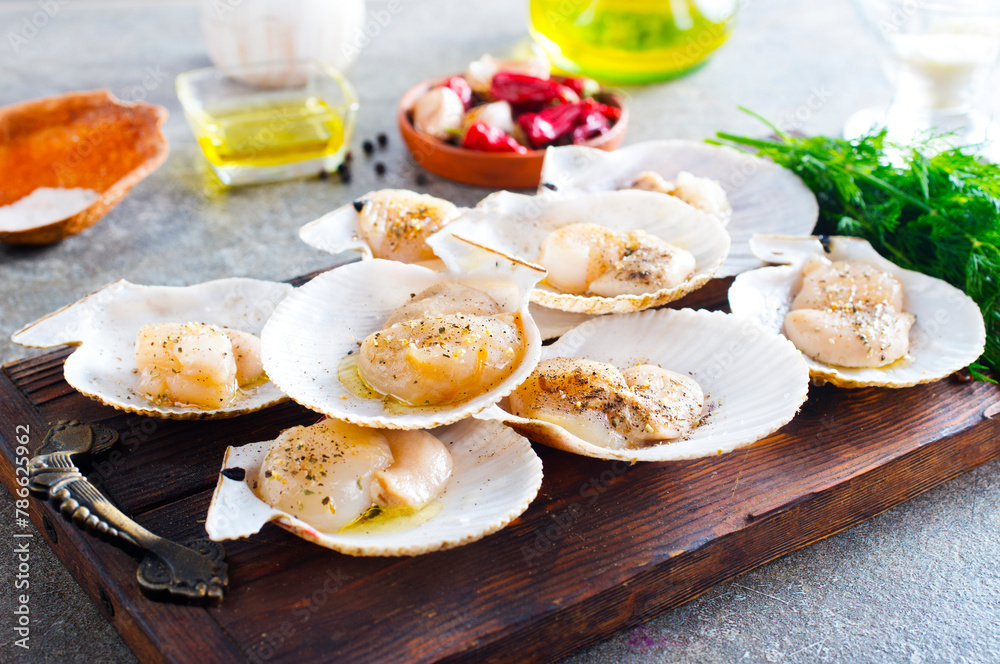 Poster from above fresh appetizing scallop with shell served on wooden boars