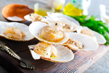 From above fresh appetizing scallop with shell served on wooden boars - 786625926