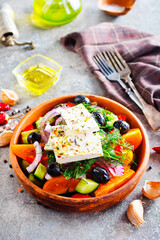 Greek salad of fresh cucumber, tomato, sweet pepper, lettuce, red onion, feta cheese and olives with olive oil. Healthy food, top view - 786627935