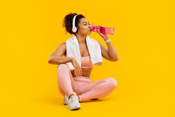 Woman sitting with water bottle after exercise