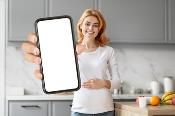 Pregnant woman showing smartphone with blank screen