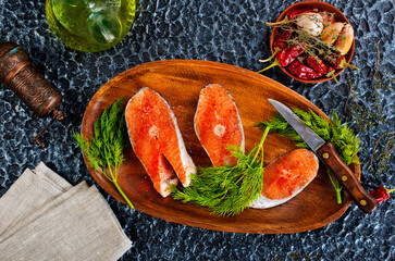 fresh salmon steak raw fish prepared for cooking. Top view on black slate table. - 786630364