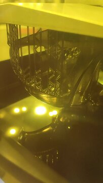 3D printer working process. 3D printing. Stereolithography photopolymerization SLA. Additive manufacturing technology. Liquid materials, hard part, creating layers. Ultraviolet polymerization Vertical