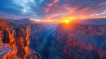 Fotobehang Breathtaking sunset over a majestic canyon with a visible suspension bridge in a rugged landscape © Yusif